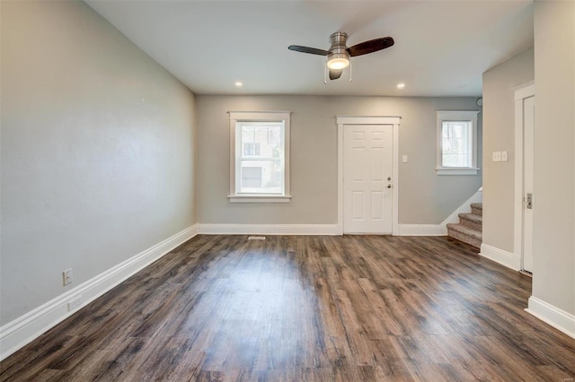 empty room featuring ceiling fan and dark hardwood / wood-style flooring