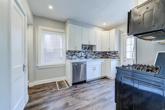 kitchen featuring white cabinets, dishwasher, plenty of natural light, and hardwood / wood-style flooring