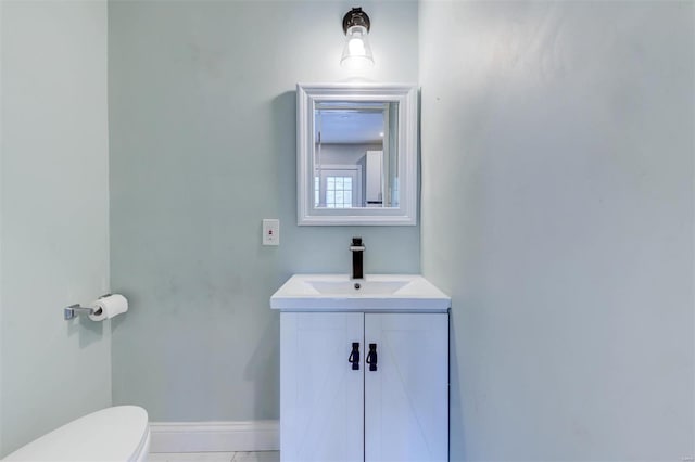 bathroom featuring vanity, toilet, and tile patterned flooring