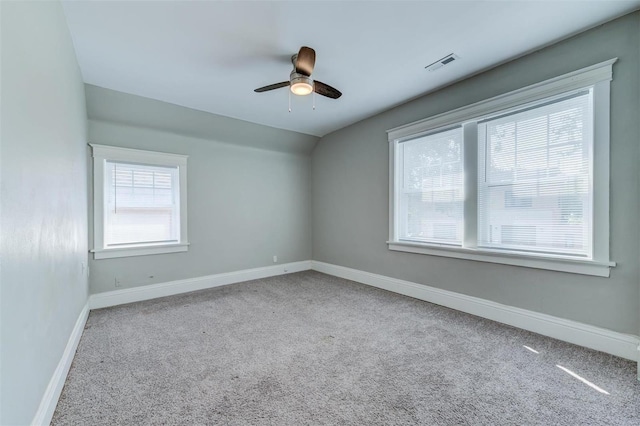 spare room featuring lofted ceiling, ceiling fan, and light carpet