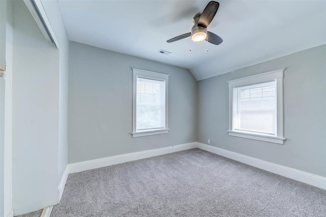 carpeted empty room with vaulted ceiling and ceiling fan