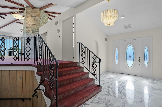 foyer with high vaulted ceiling, beam ceiling, and ceiling fan with notable chandelier