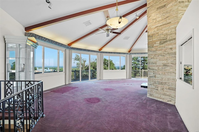 interior space with lofted ceiling with beams and ceiling fan