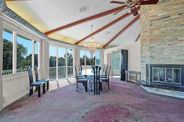 sunroom with plenty of natural light, a stone fireplace, ceiling fan with notable chandelier, and vaulted ceiling with beams