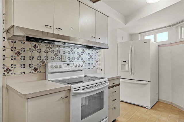 kitchen featuring tasteful backsplash and white appliances