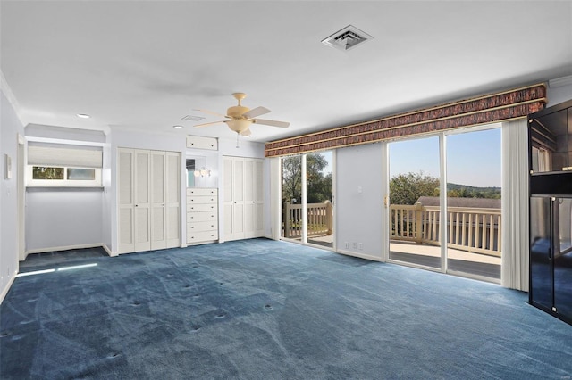 unfurnished living room featuring ornamental molding, ceiling fan, and dark colored carpet