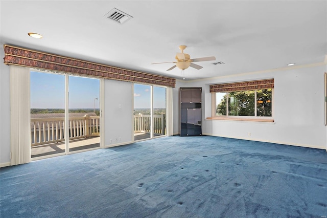 spare room featuring carpet floors and ceiling fan