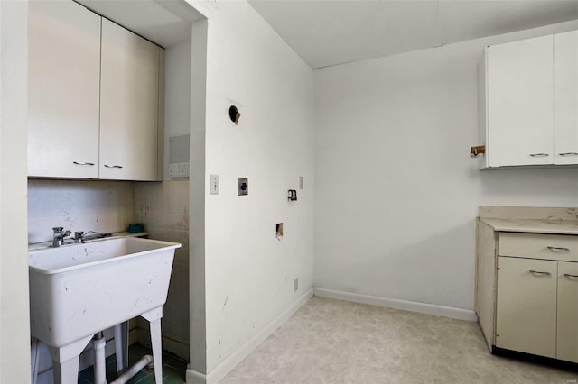 laundry area with cabinets, sink, and hookup for an electric dryer