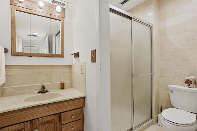 bathroom with toilet, tile walls, vanity, and walk in shower