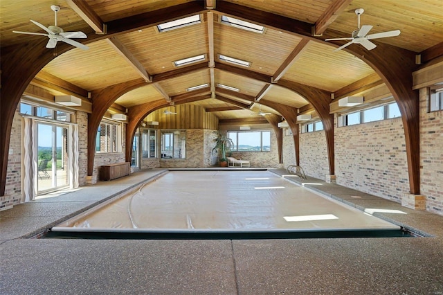 interior space featuring ceiling fan and a skylight