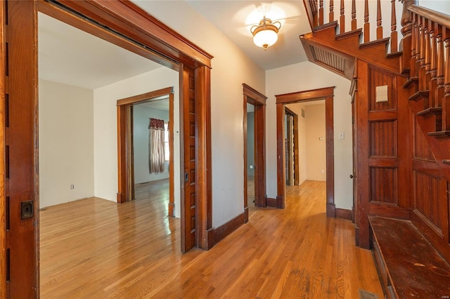 corridor with light hardwood / wood-style flooring