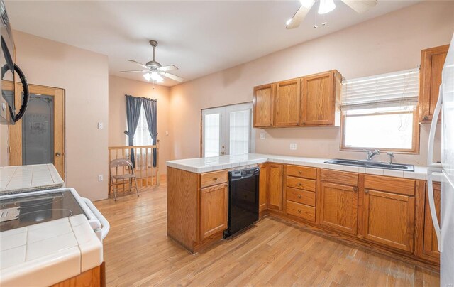 kitchen with kitchen peninsula, dishwasher, ceiling fan, and sink