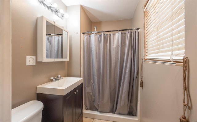 bathroom with vanity, tile patterned floors, toilet, and curtained shower