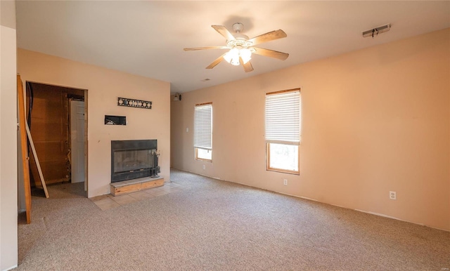 unfurnished living room with ceiling fan and light colored carpet