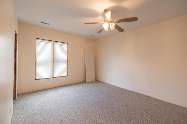 spare room featuring carpet floors and ceiling fan