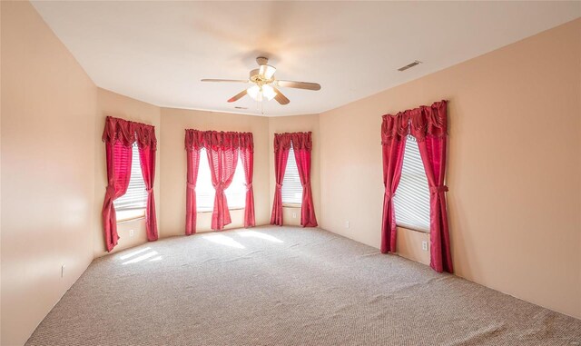 spare room with ceiling fan and carpet flooring