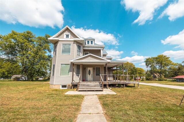 view of front of house with a front yard and a porch