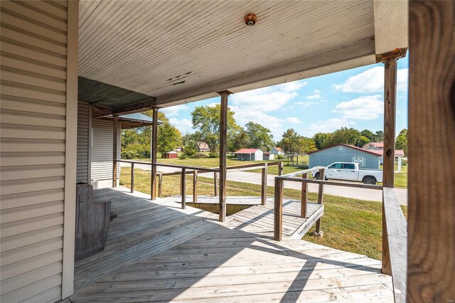 wooden deck with a lawn