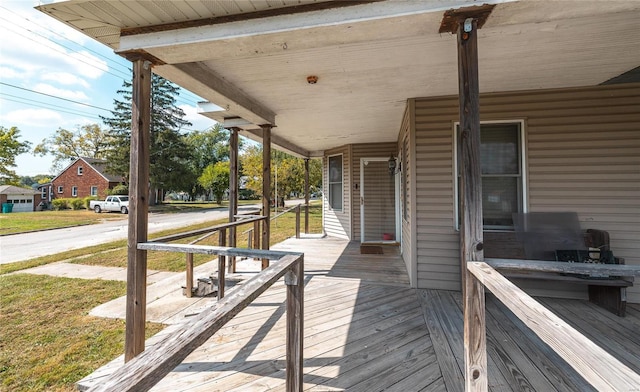 wooden deck with a lawn