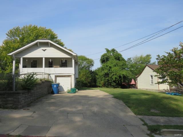 exterior space with a garage and a yard