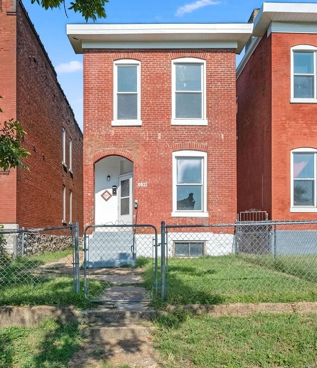 view of front of home with a front lawn and central air condition unit