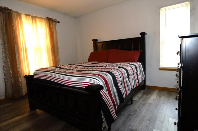 bedroom with dark hardwood / wood-style floors