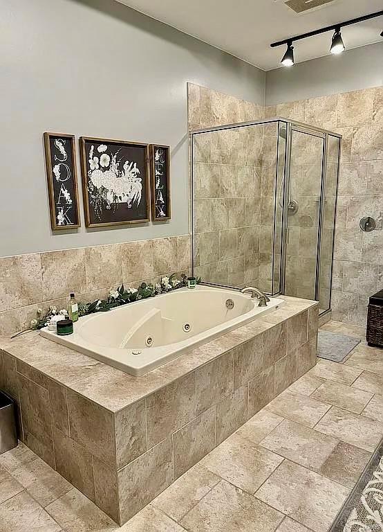 bathroom with separate shower and tub