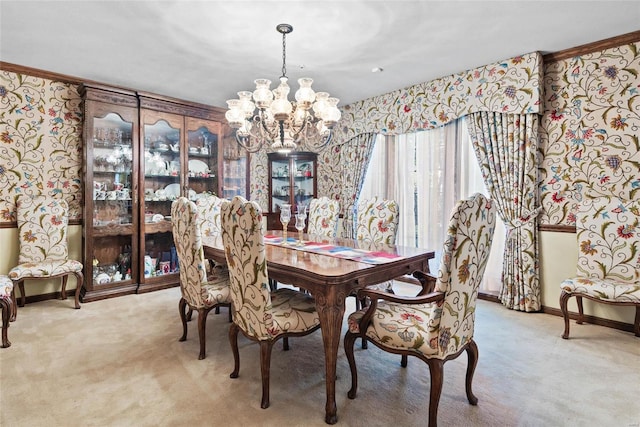 carpeted dining area with an inviting chandelier and crown molding