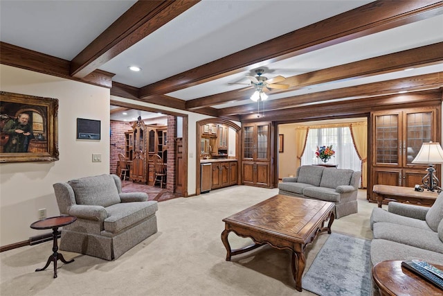 living room with beamed ceiling, ceiling fan, and light carpet