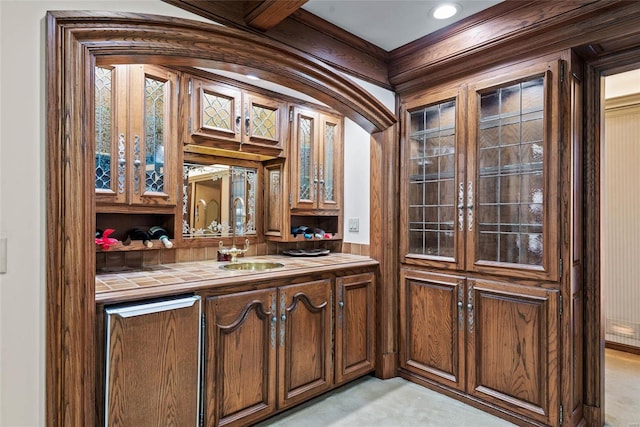 bar with light carpet, sink, and tile counters