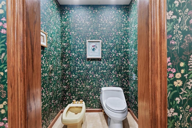 bathroom with a bidet and toilet