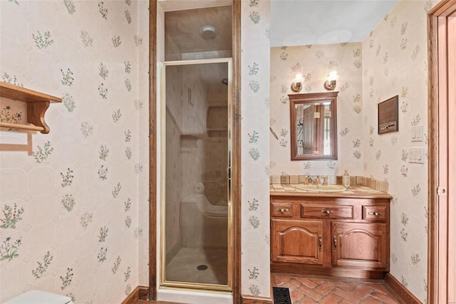 bathroom with vanity, toilet, and a shower with shower door