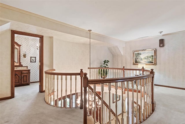 hall with crown molding, carpet flooring, and a chandelier