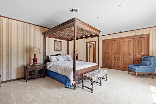 bedroom with carpet floors and crown molding