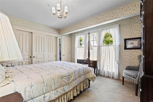 carpeted bedroom featuring a chandelier