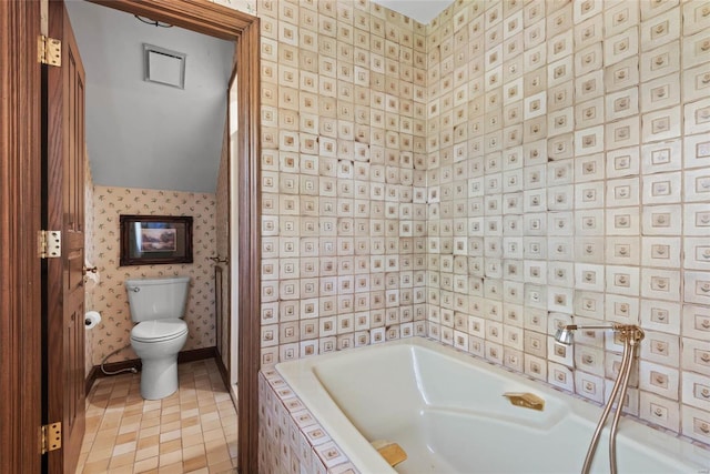 bathroom with independent shower and bath, toilet, and tile patterned floors