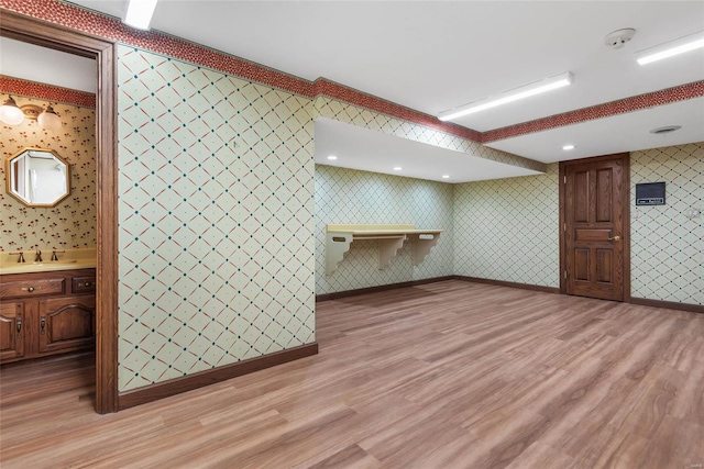 interior space featuring light wood-type flooring and sink