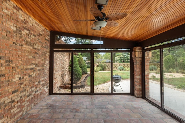 unfurnished sunroom featuring wooden ceiling, lofted ceiling, and plenty of natural light