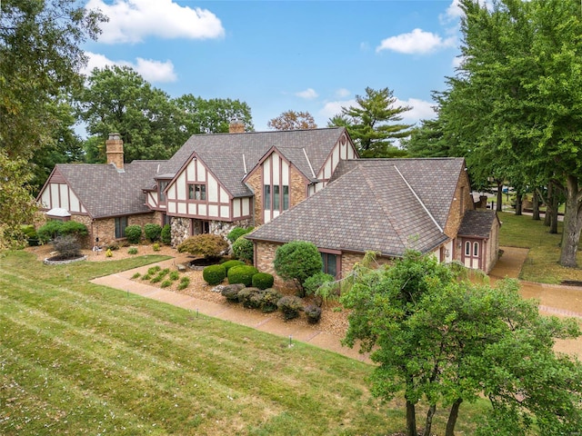 tudor house featuring a front yard