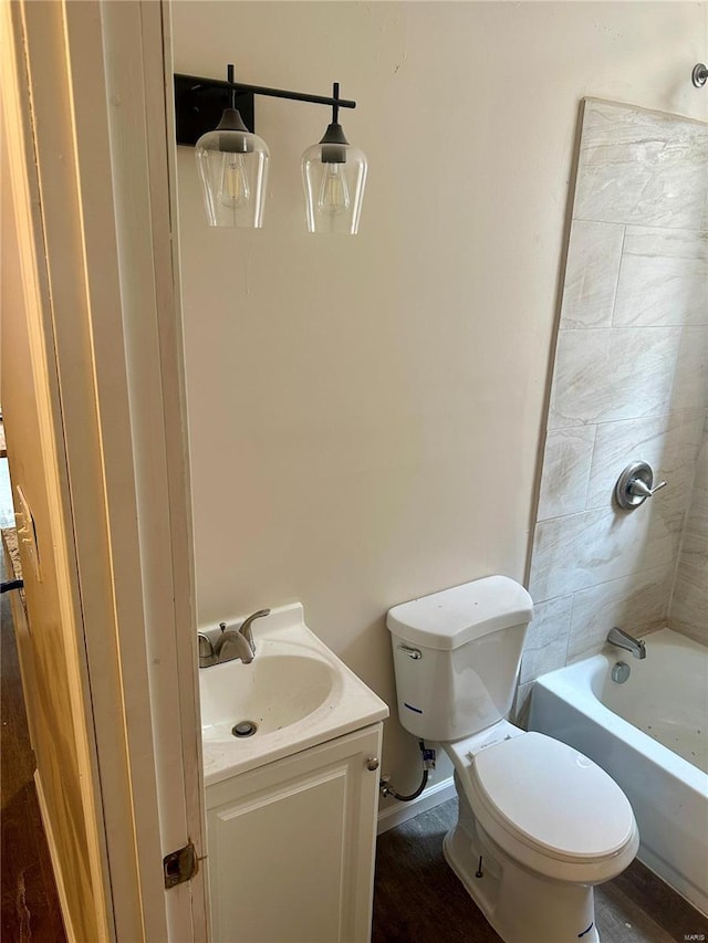 full bathroom with vanity, toilet, hardwood / wood-style flooring, and bathtub / shower combination