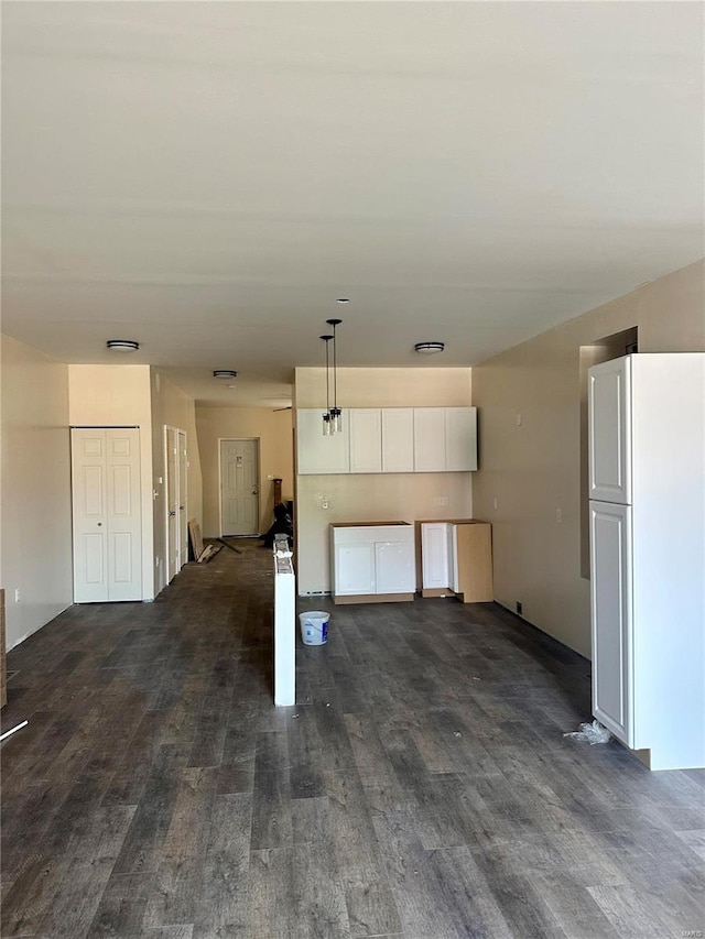 unfurnished living room with dark hardwood / wood-style flooring