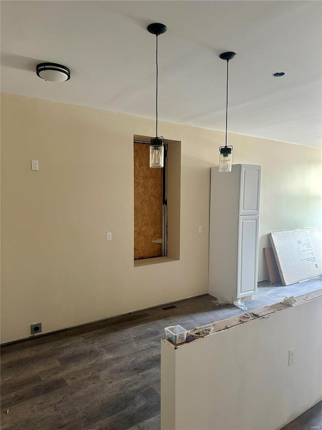 kitchen with pendant lighting and dark hardwood / wood-style floors