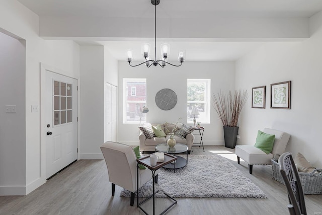 living room featuring light hardwood / wood-style flooring and an inviting chandelier