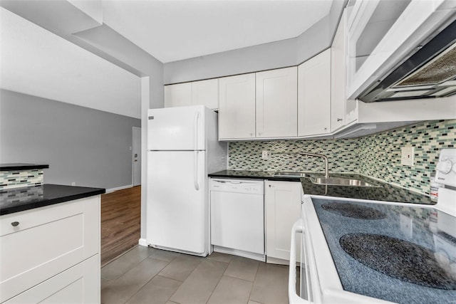 kitchen featuring white appliances, range hood, sink, decorative backsplash, and white cabinetry