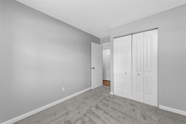 unfurnished bedroom with carpet floors and a closet