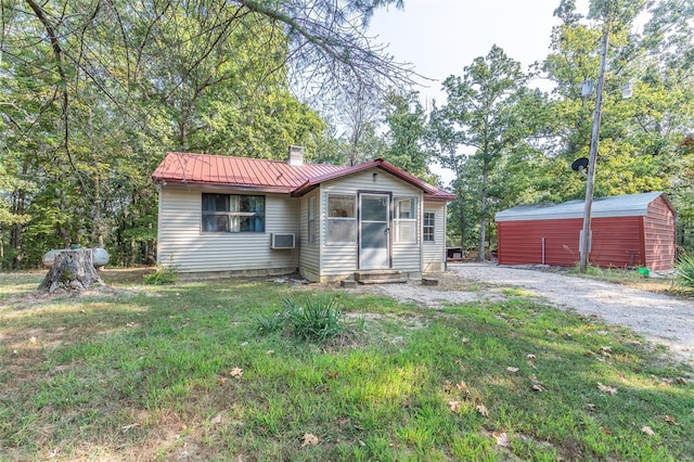 view of front of home with an outbuilding and a front yard