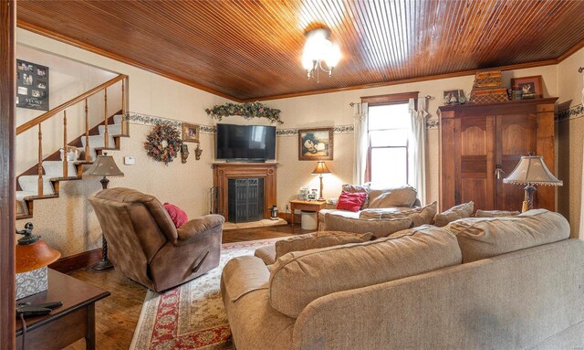 living room featuring wood ceiling, wood-type flooring, and crown molding