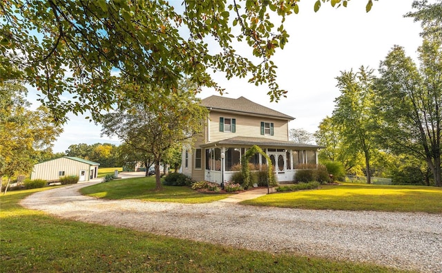 view of front of property with a sunroom and a front lawn