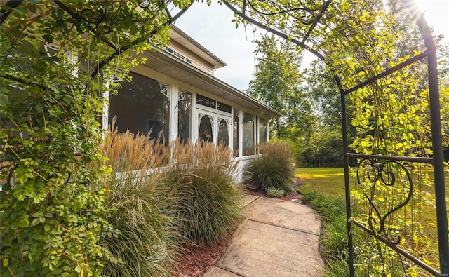 view of side of home with a lawn