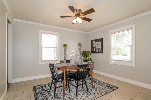 tiled dining space with crown molding and ceiling fan